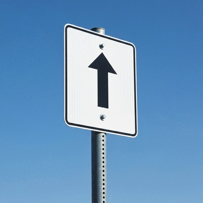 Close up of a clean metal parking sign on a sunny day with blue sky background